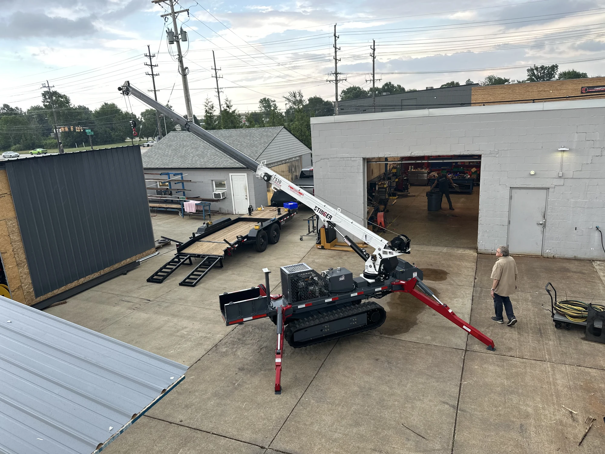 Completed tracked equipment with outriggers extended outside UPCO’s workshop